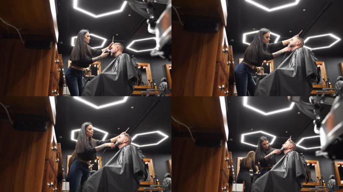 理发师在理发店用修剪器剪掉男人的胡须。沙龙中的男士发型和理发。用剪刀梳理头发。理发师在复古发廊理发