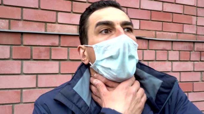 男子戴着医用口罩，气喘吁吁，窒息，生病，沉重的咳嗽，气喘吁吁，受苦。肖像