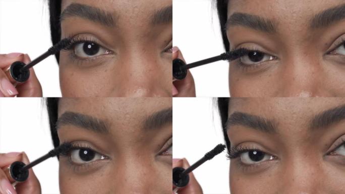 女性棕色眼睛的特写镜头。非洲女人涂睫毛膏。美容和化妆概念。孤立，在白色背景上