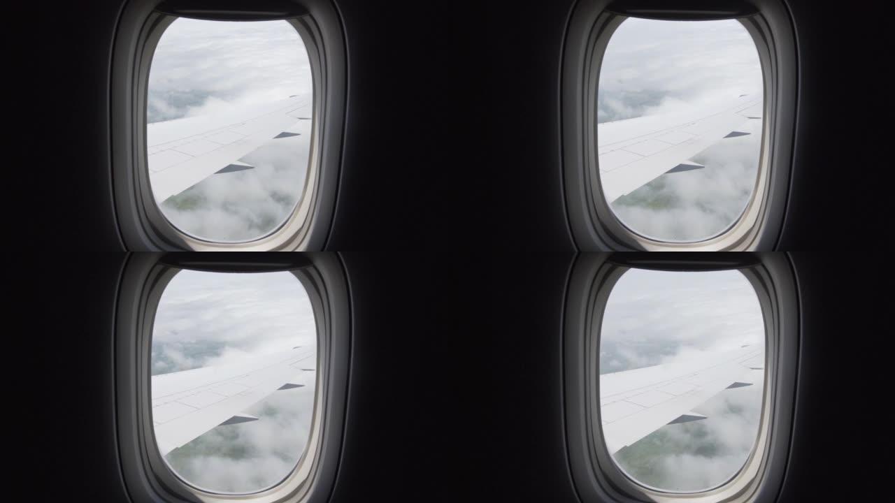 从飞机窗外看向移动的云层，看机翼