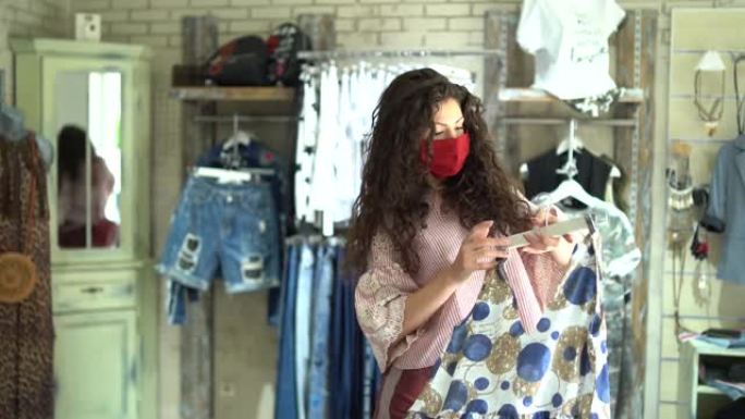 4k视频女人戴着防护面具，新型冠状病毒肺炎后重新开店购物