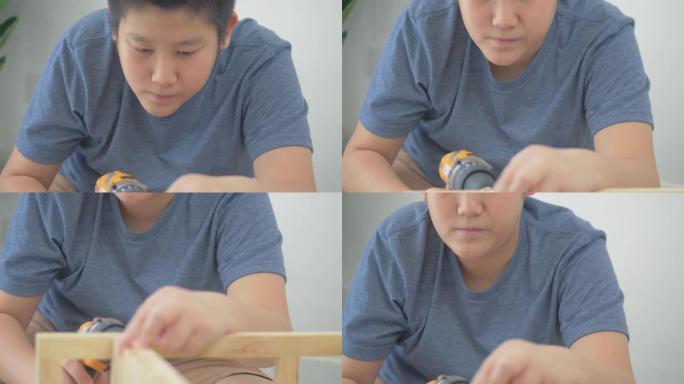 亚洲男孩学习如何DIY木制架子。