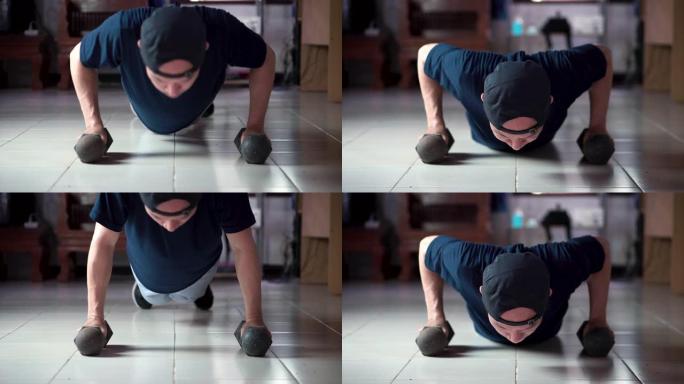 亚洲男子在家做俯卧撑健身运动慢动作，病毒新型冠状病毒肺炎情况
