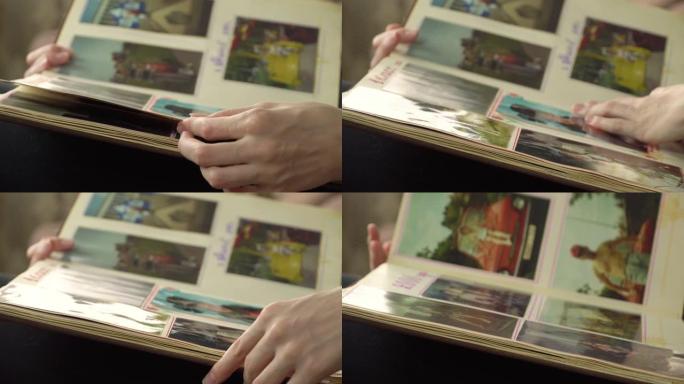 女人正在家里看旧相册。一个女人回忆起过去，就像以前一样。