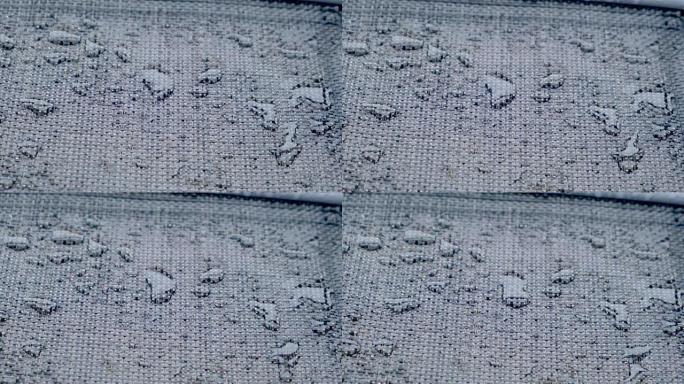 具有许多雨滴的防水材料的特写纹理