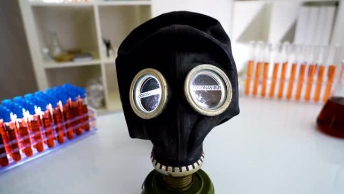 带有冠状病毒或新型冠状病毒肺炎的黑色危险面具的实验室室内桌子的视图
