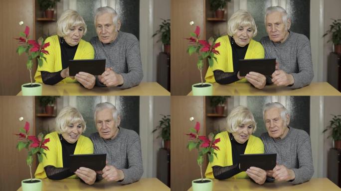 相当成熟的老年夫妇祖父母在家享受平板电脑网上购物