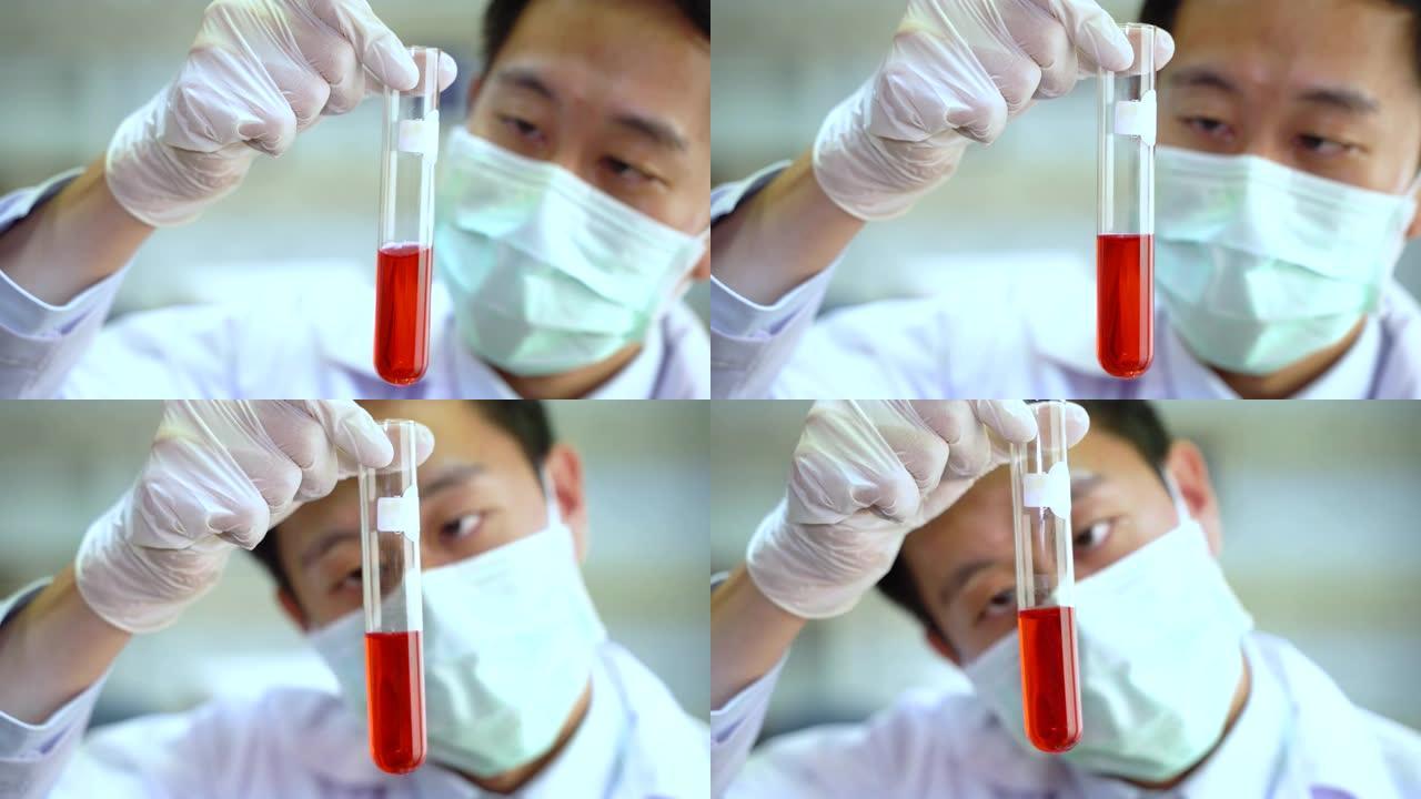 用红色化学溶液拿着实验室烧瓶的白色制服的亚洲男性科学家的特写镜头。化学、科学、生物学、毒理学、研究与