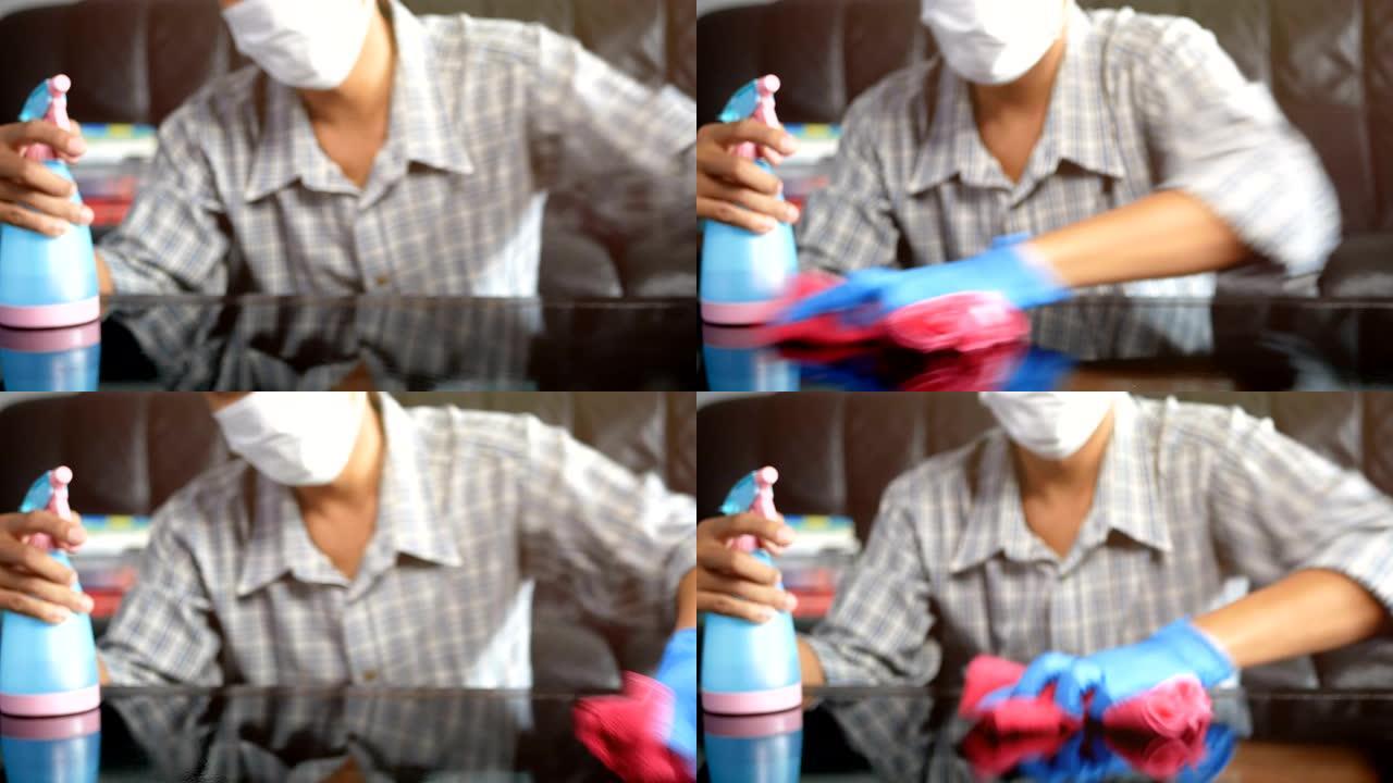4K.手握粉色超细纤维清洁布和带消毒液的喷雾瓶清洁消毒，保持良好的卫生习惯，防止传播冠状病毒新型冠状