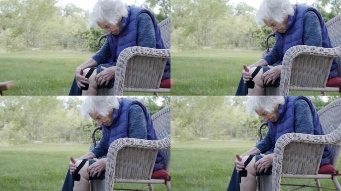 夏季户外中午，一名老年高加索妇女的膝关节关节炎疼痛的个人资料