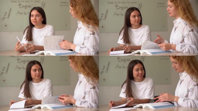 英语老师用笔记本电脑问白人班的学生。2女生对老师的回答。集体工作。学习英语和英国语言。