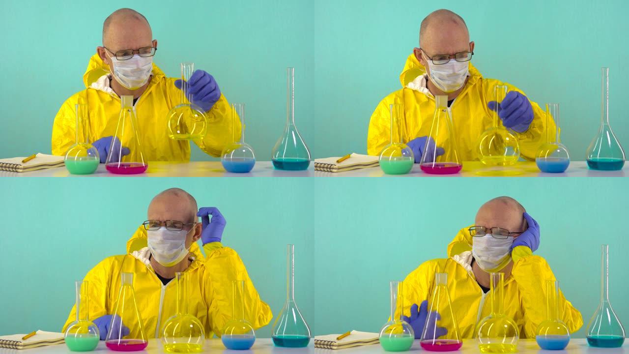 一位化学实验室助理穿着黄色防护服，戴着手套和眼镜，在他面前的是装有试剂的烧瓶，他正在考虑从哪里开始实