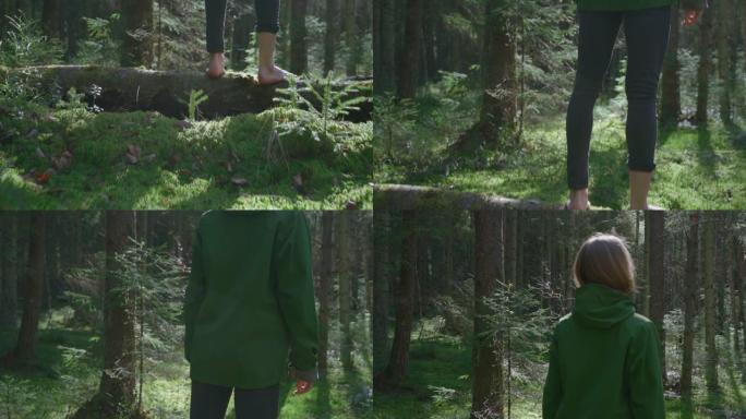 年轻女子喜欢光着脚站在森林里一棵长满青苔的倒下的树上。