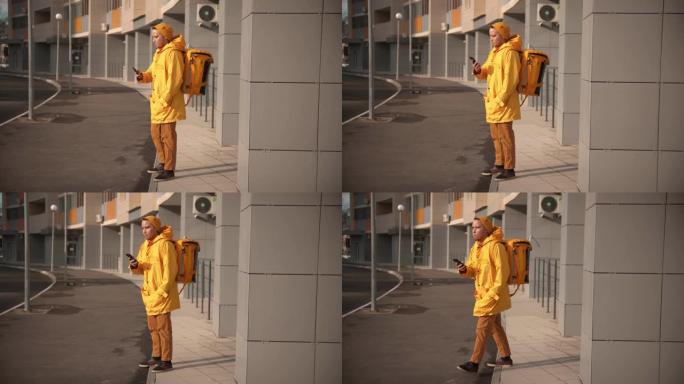 穿着黄色衣服的男子快递员运送食物-走出门廊