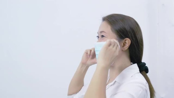 亚洲女性戴着医用口罩，以防止空气中的细菌。卫生概念防止细菌和细菌的传播，避免冠状病毒感染。