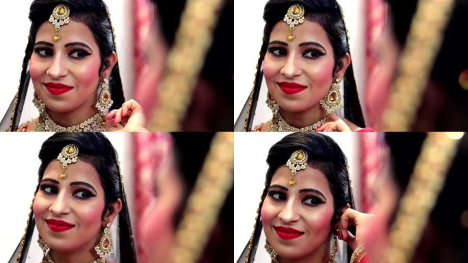美丽的年轻印度新娘照镜子