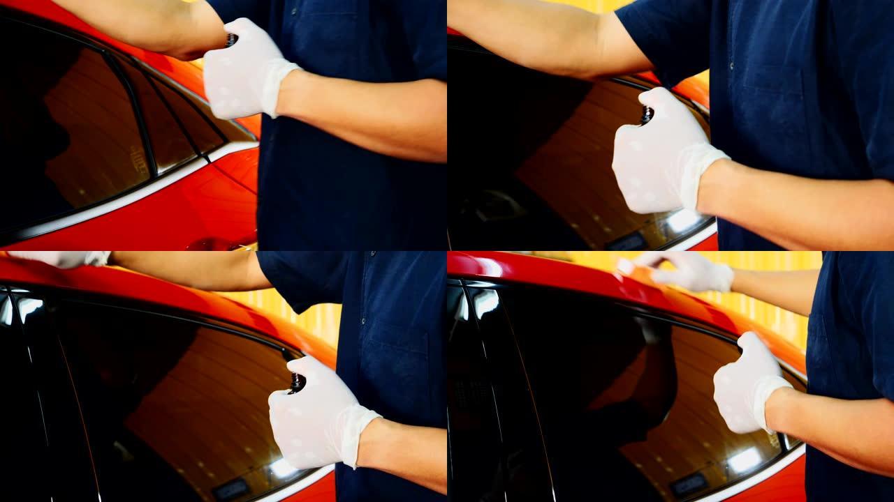 汽车细节-在继续涂覆陶瓷之前，男士正在使用汽车抛光机维护去除痕迹，根据汽车油漆的表面进行修复