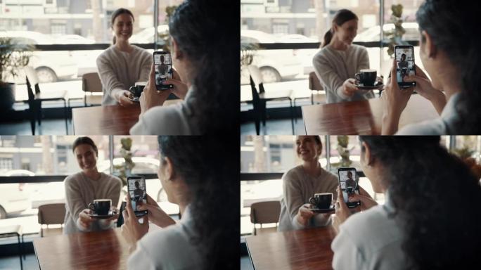 女人在咖啡馆里拍她的朋友拿着咖啡