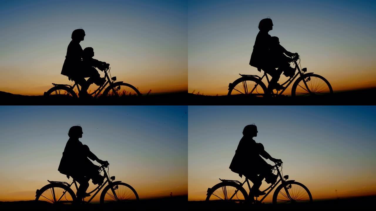 在美丽的夏日夜晚，妈妈和孩子骑自行车的剪影