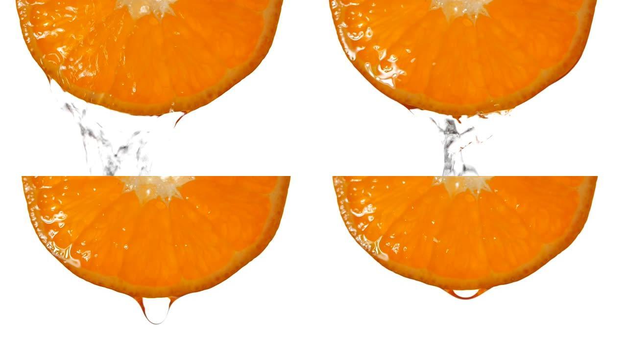 橙色切片果汁水在白色背景上慢动作飞溅