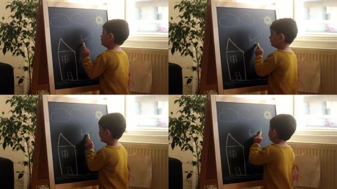 男孩在黑板上画画