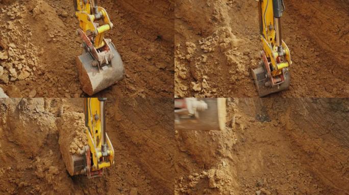 大型挖掘机铲斗从沟渠中提取土壤