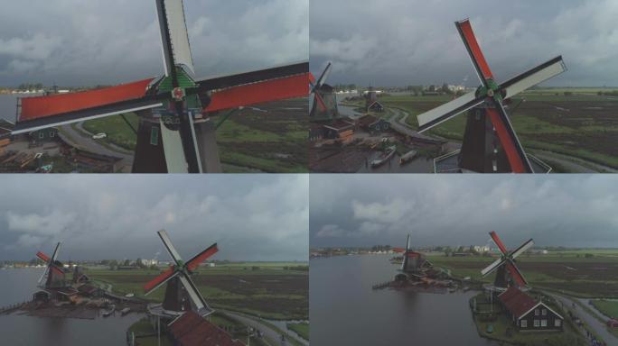 从扎安斯·谢斯 (Zaanse Schans) 北荷兰的传统历史悠久的荷兰风车旋转的彩色叶片中空中拉