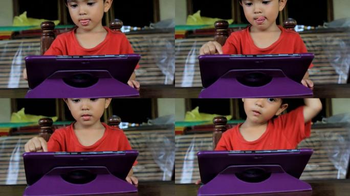 亚洲泰国小男孩使用数字平板电脑