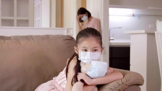 冠状病毒在家隔离时戴着医用口罩的孩子和母亲