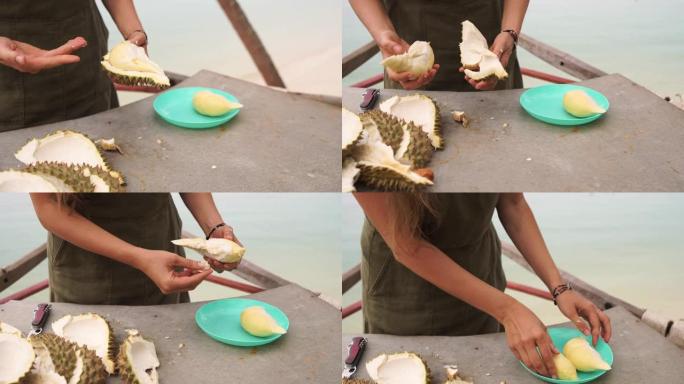 迷人的旅游女人敞开心扉，尝试吃异国情调的榴莲水果。印度尼西亚巴厘岛。
