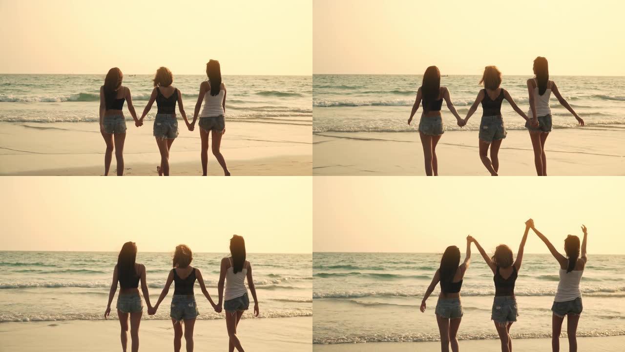 4k后视组年轻美丽的亚洲女性女孩朋友在日落时一起在沙滩上散步和跑步，笑着一起微笑。迷人的女人友谊在暑