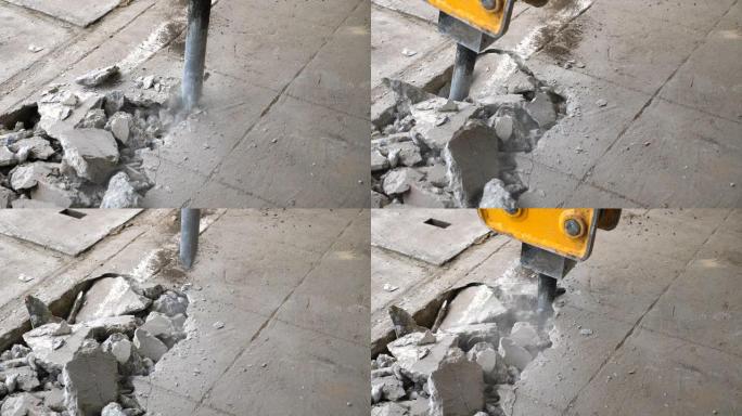 手提钻挖掘混凝土地板，特写镜头