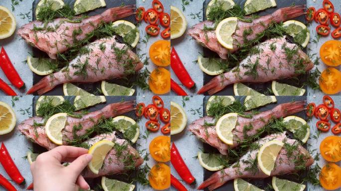 生鱼和供烘烤的蔬菜一起鲈鱼。厨师将柠檬片放在鱼的胴体上，以便在烤箱中烹饪