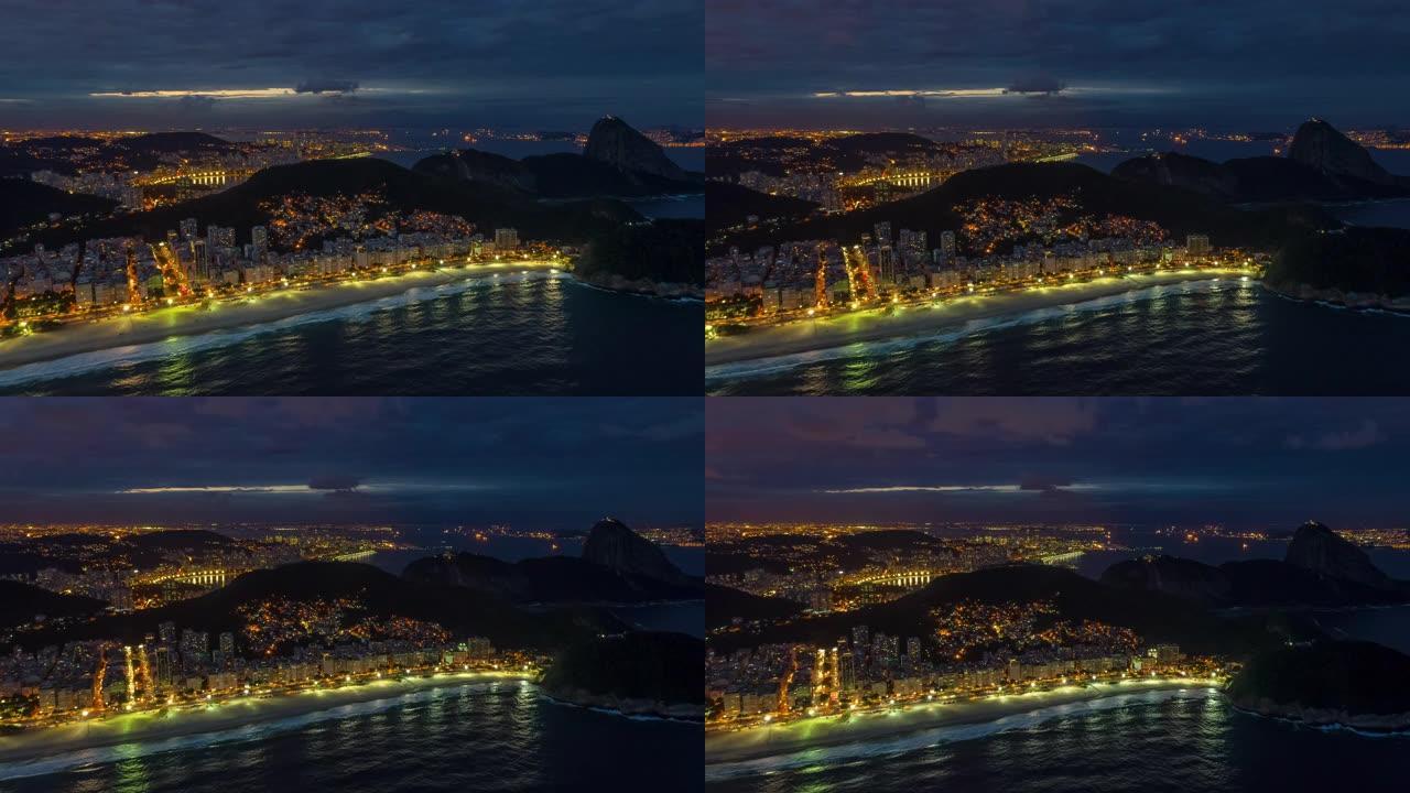 飞越里约热内卢市著名的海湾海滩暮夜照明航空全景4k延时巴西