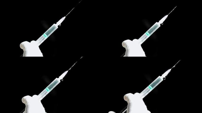 一只手拿着注射器，然后从针头中喷出药液或疫苗