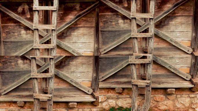 手工制作的旧木梯靠在传统的乡间别墅上。