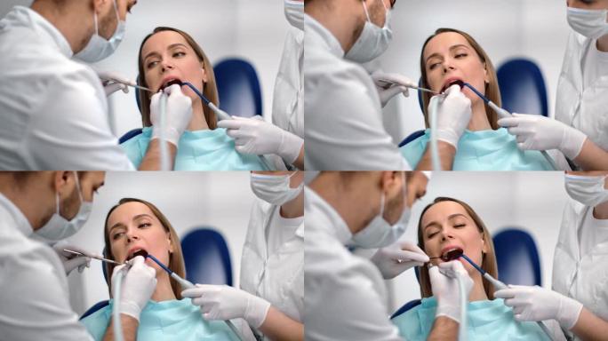 患有龋齿的女性患者在口腔诊所去看牙医。在4k红色相机上近距离拍摄