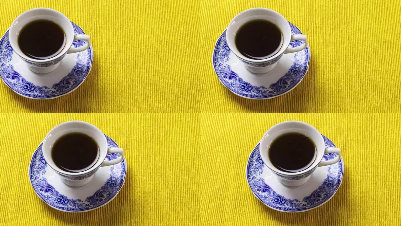 黄色餐垫上的中国瓷器咖啡杯