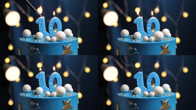 生日蛋糕10号星星天空和月亮概念，蓝色蜡烛被打火机点燃，然后吹灭。如果需要，请在屏幕右侧复制空间。特