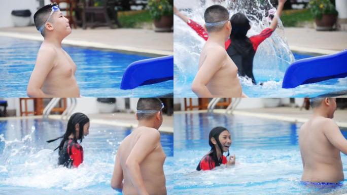 快乐的亚洲青春期男孩看着他的妹妹玩水滑块，慢动作。