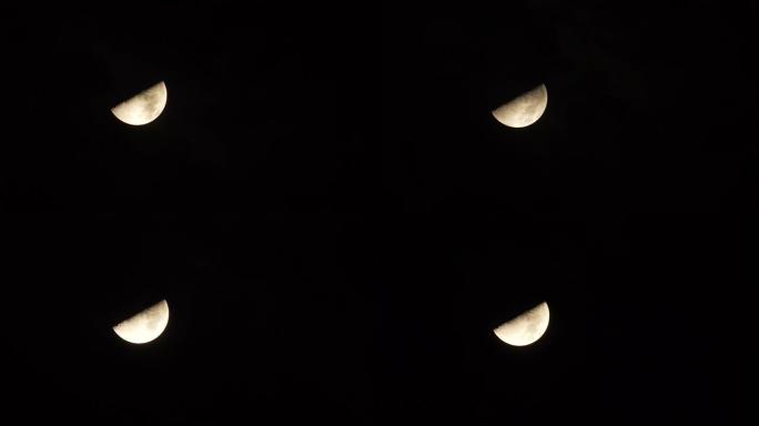 夜晚有黑色天空背景的满月特写，云朵移动，月光闪耀，长焦镜头4k视频。