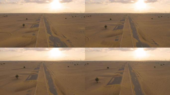 在阿拉伯联合酋长国或阿联酋的迪拜市，半沙漠道路或沙丘街道的鸟瞰图。日落时的自然景观背景。著名的旅游景