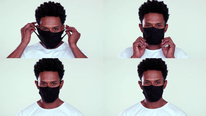 非洲男子戴上预防性新型冠状病毒肺炎面具。戴着黑色面具对抗大流行肖像的人
