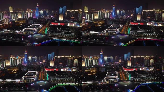 夜间照明青岛市著名奥林匹克湾广场交通街空中全景4k中国