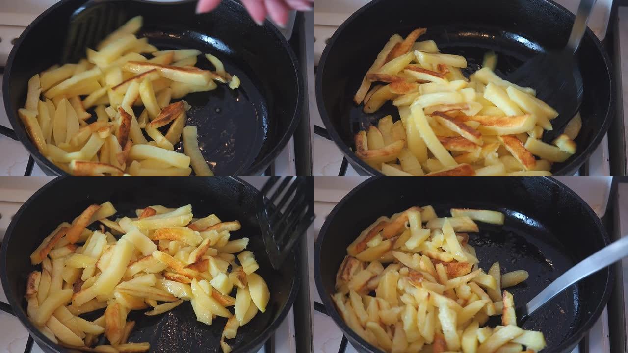土豆在油锅里油炸。烹饪炸土豆。用厨房刮铲搅拌土豆片以防止燃烧