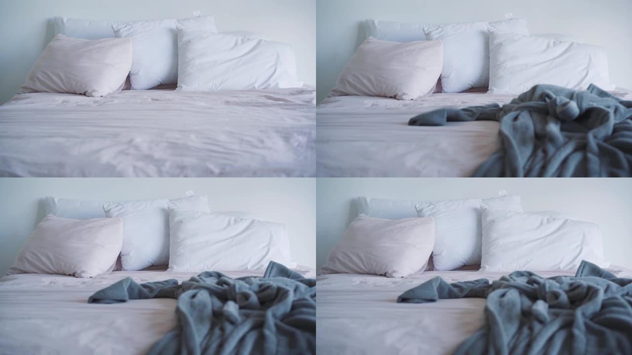 卧室大床的前视图，浴袍落在床上。早上好，酒店房间，放松，休息。