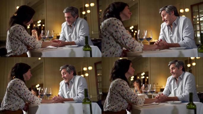 丈夫和妻子在周年纪念日在餐厅享用葡萄酒