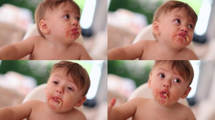 可爱的宝宝吃着嘴咀嚼着。可爱的婴儿幼儿咀嚼食物