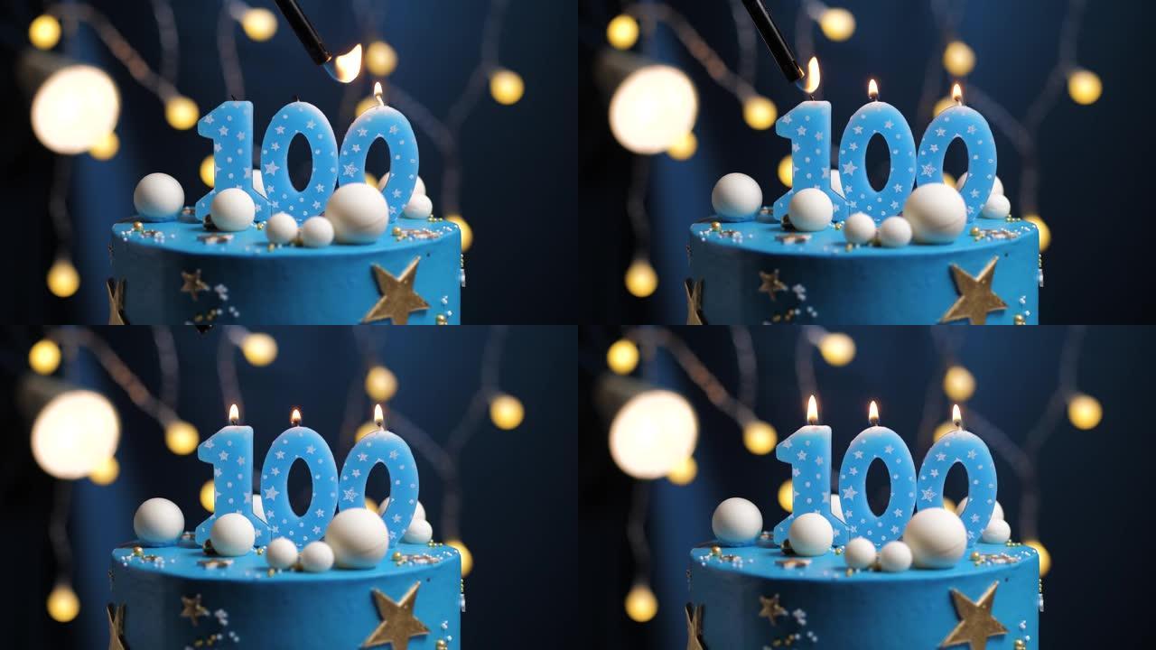生日蛋糕编号100星星天空和月亮概念，蓝色蜡烛被打火机点燃，然后吹灭。如果需要，请在屏幕右侧复制空间