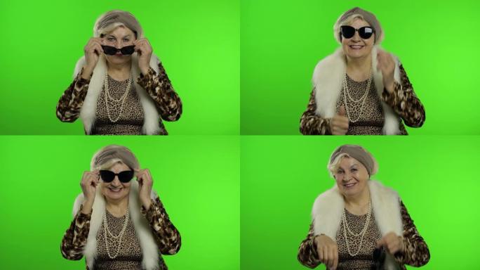 老式白人奶奶戴上太阳镜。色度键背景